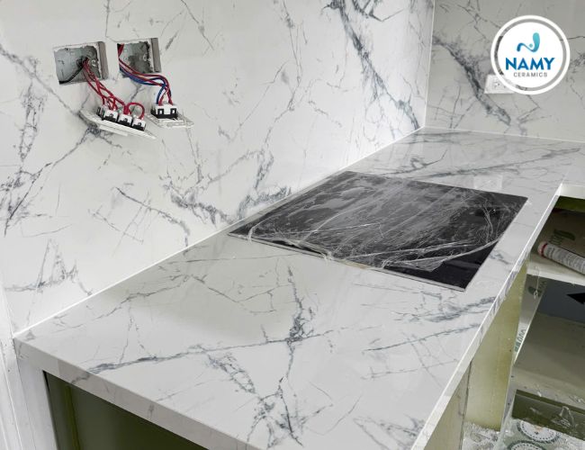 Bàn bếp tông trắng được gia chủ phối với nội thất tông xanh nhẹ. 
